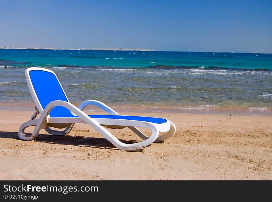 Blue chaise lounge at the sea