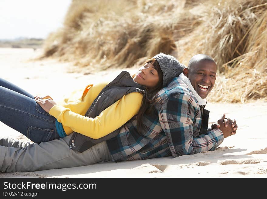 Romantic Young Couple On Winter Beach Smiling.