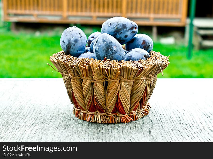 Plums in a wicker basket