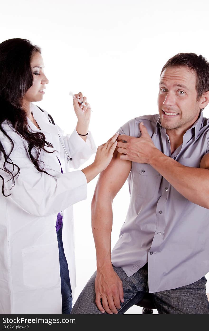 A woman doctor is giving her male patient a shot. A woman doctor is giving her male patient a shot.