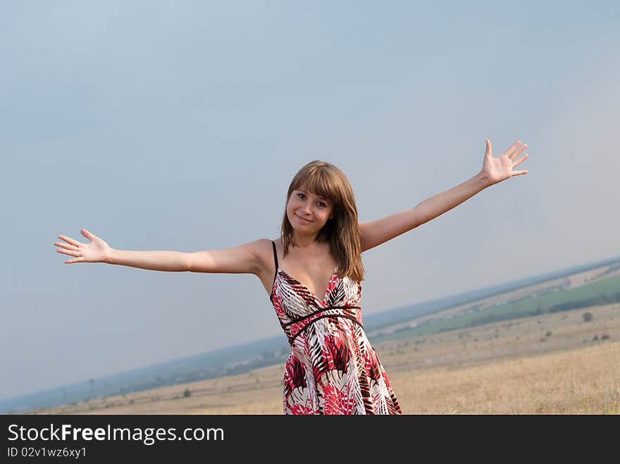 Young smiling, happy, the girl has thrown up hands upwards. Young smiling, happy, the girl has thrown up hands upwards.