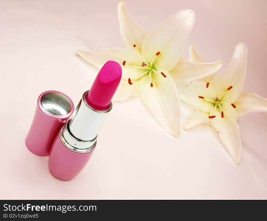 Red Lipstick With Lilies On Background