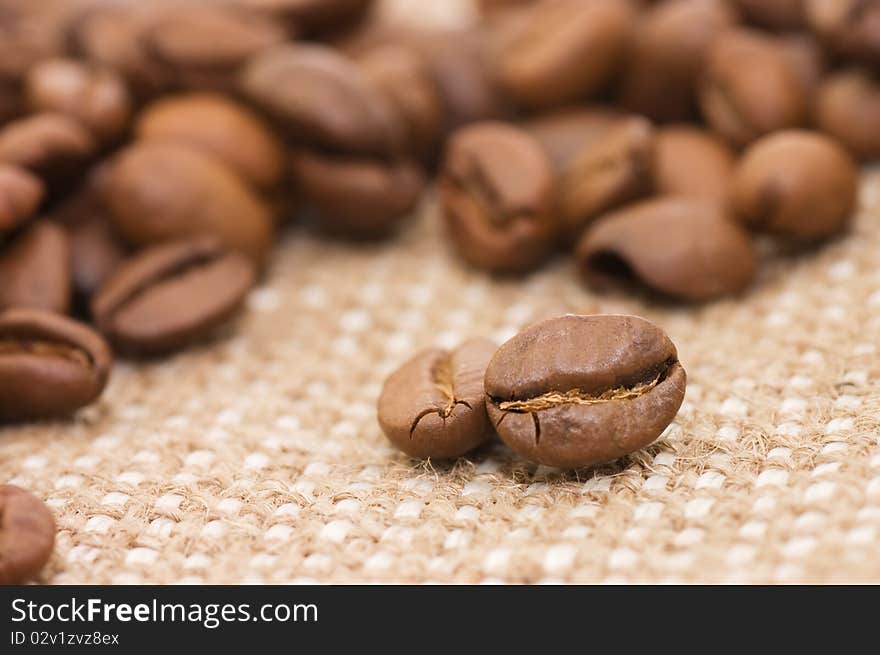 Brown coffee grains on a sacking close up