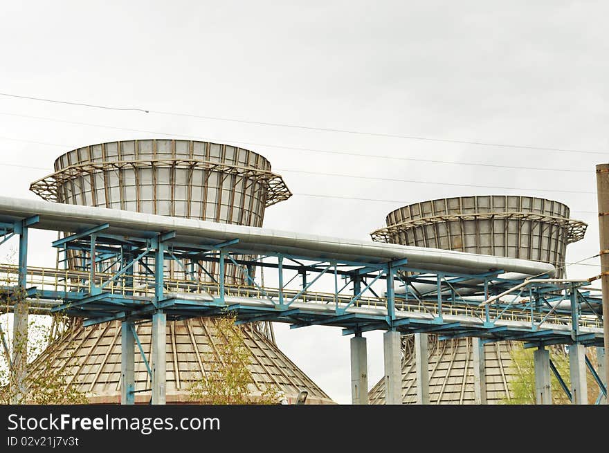 Tube on the background of large pipes; an industrial district; horizontal. Tube on the background of large pipes; an industrial district; horizontal