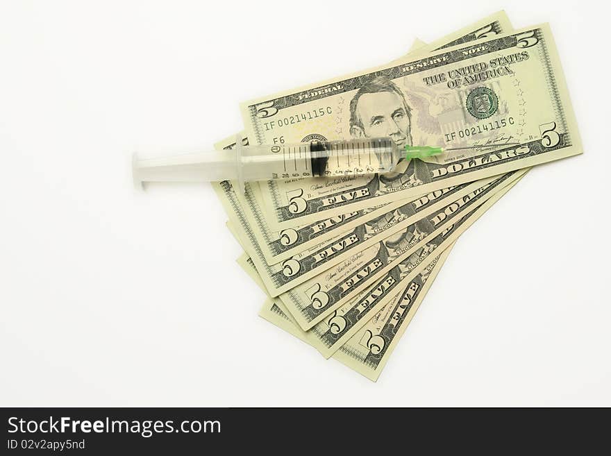 Five dollar bills and syringe