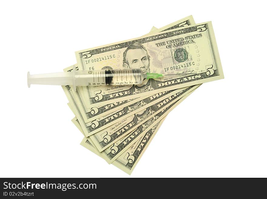 Five dollar bills and syringe isolated on white background