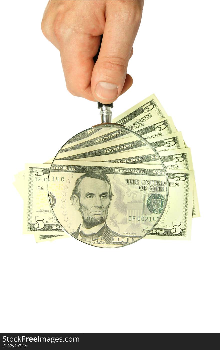 Dollar bill and hand holding magnifying glass