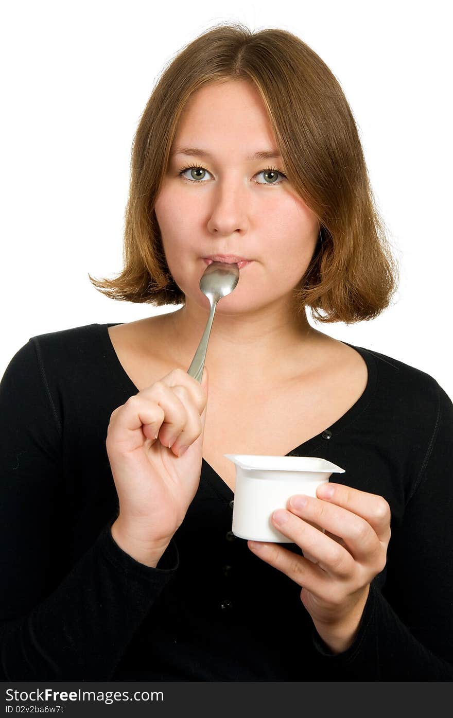 Woman is licking spoon over white. Woman is licking spoon over white