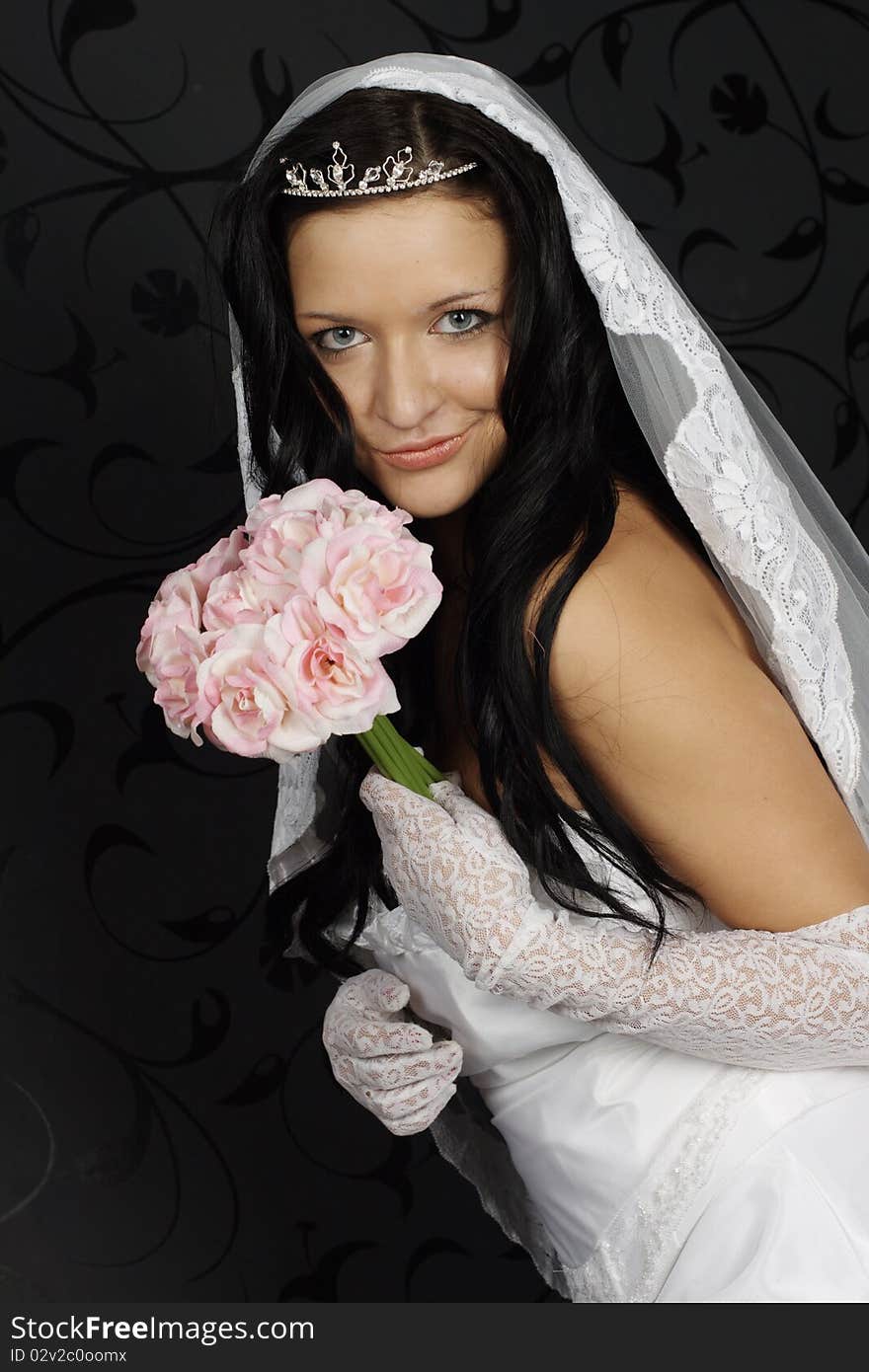 Portrait of beautiful happy bride in a wedding dress on black background studio shot. Portrait of beautiful happy bride in a wedding dress on black background studio shot