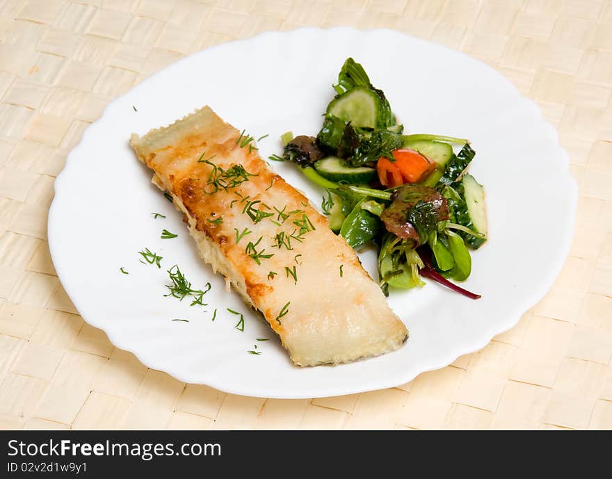 Fried piece of fish with vegetable salad. Fried piece of fish with vegetable salad