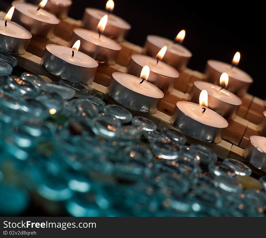 Rows of Lit Candles with Out of Focus Glass Beads. Rows of Lit Candles with Out of Focus Glass Beads