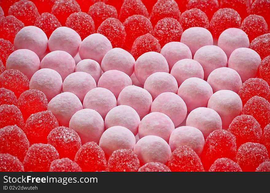 Pink heart made from bon bons and surrounded by red gumdrops. Pink heart made from bon bons and surrounded by red gumdrops