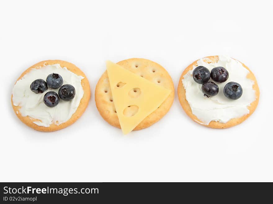 Three round crackers, snacks with cheese and fruit