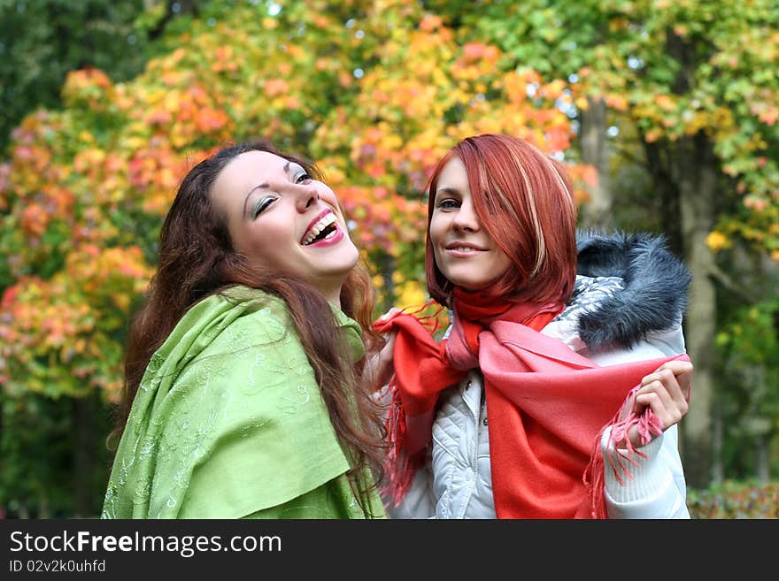 Two young girls relaxing in autumn park. Two young girls relaxing in autumn park