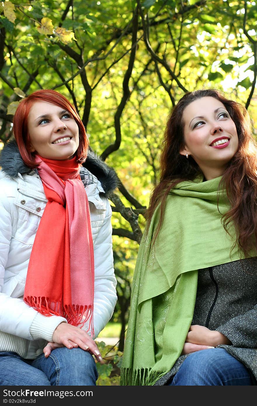 Two young girls relaxing in autumn park. Two young girls relaxing in autumn park