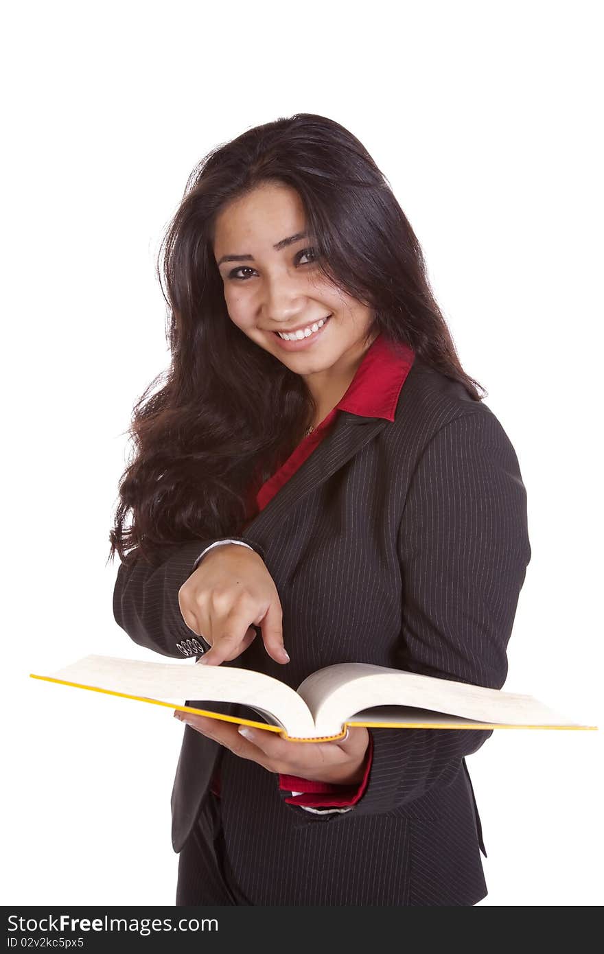 A woman is holding a book pointing and looking up. A woman is holding a book pointing and looking up