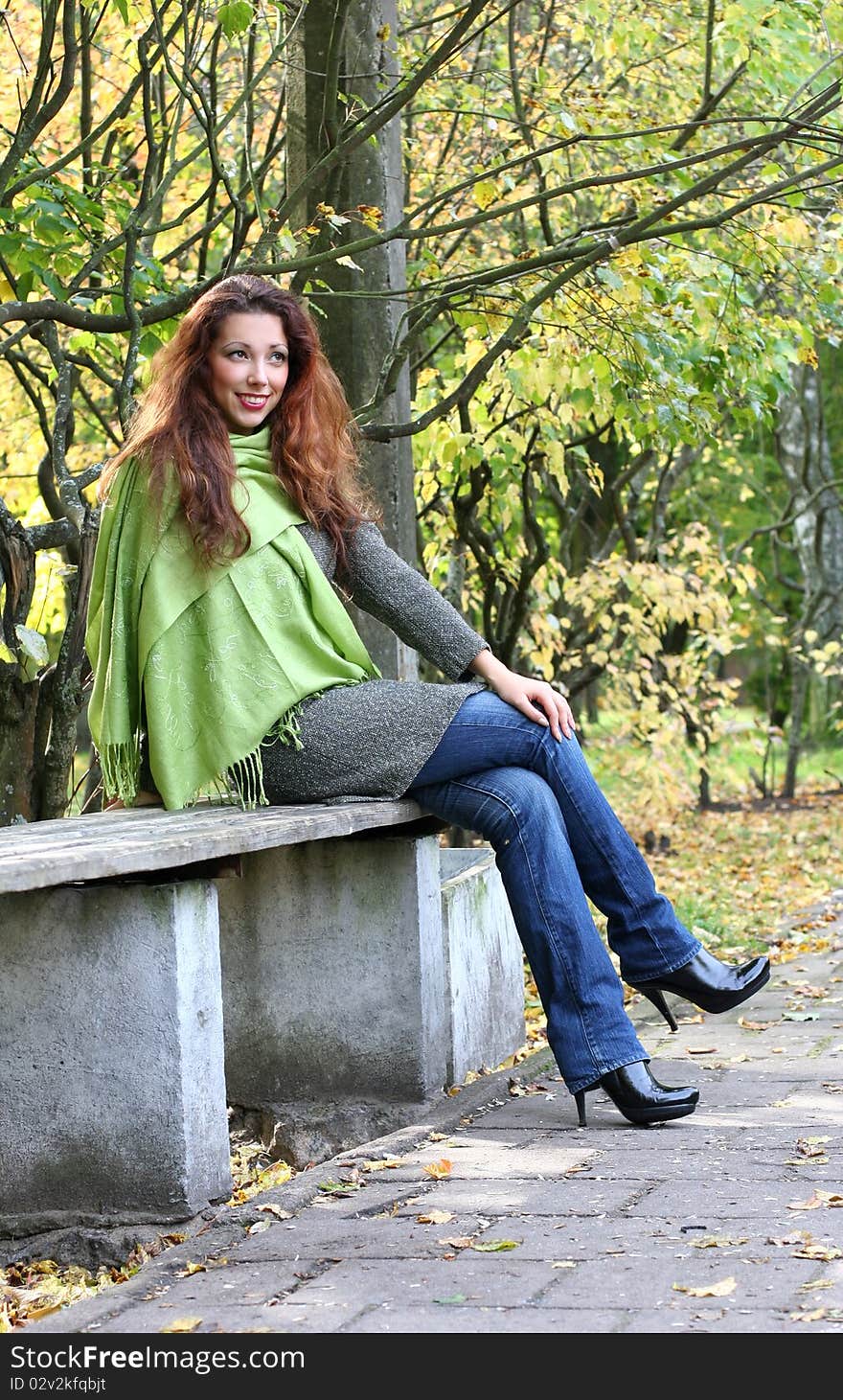 Young girl relaxing in autumn park. Young girl relaxing in autumn park