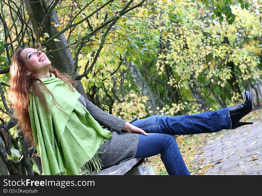 Young girl relaxing in autumn park. Young girl relaxing in autumn park