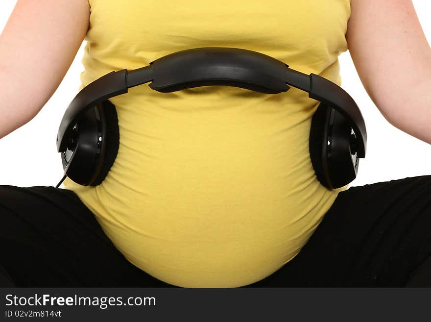 Set of headphones on pregnant belly. Set of headphones on pregnant belly