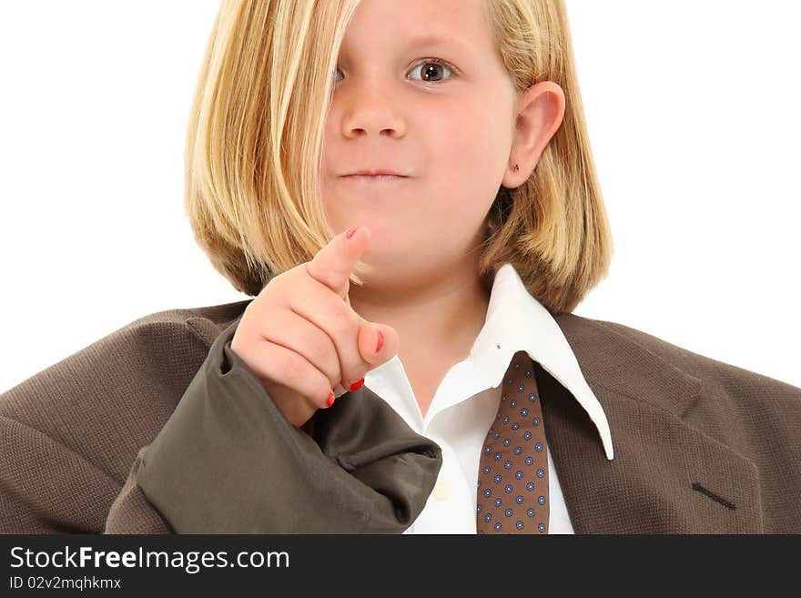 Adorable 7 year old blond american girl in baggy suit pointing angry towards camera over white background. Adorable 7 year old blond american girl in baggy suit pointing angry towards camera over white background.