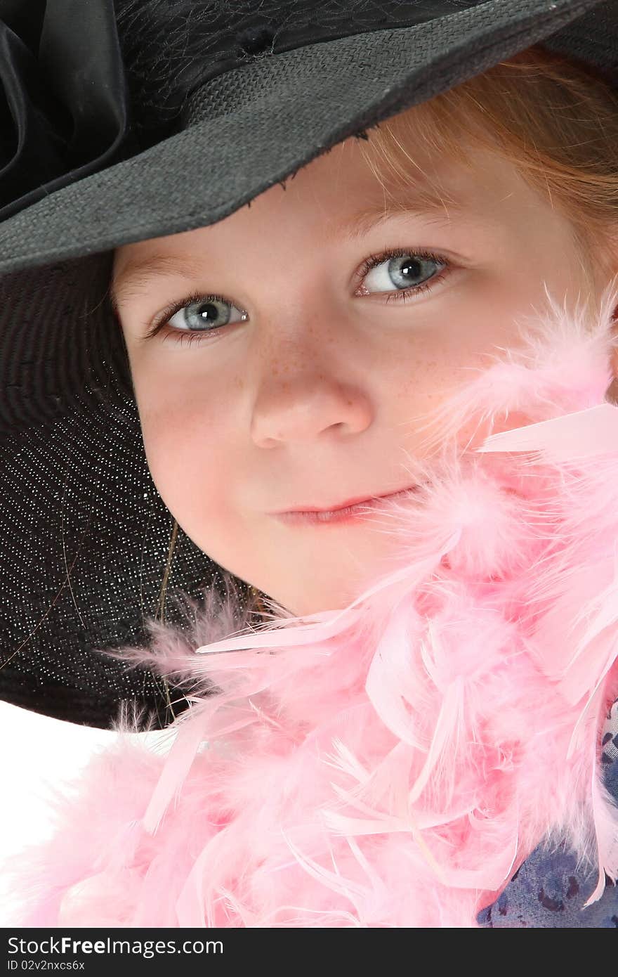 Beautiful five year old american girl in mom's dress and hat with pink feather boa over white. Beautiful five year old american girl in mom's dress and hat with pink feather boa over white.