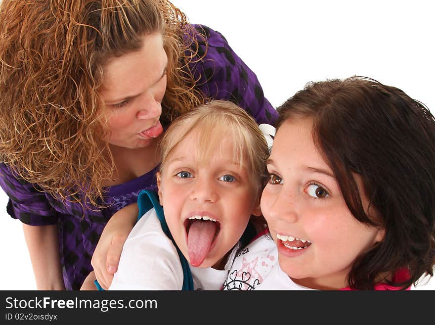 Siblings making silly faces over white background. Top view looking down. Siblings making silly faces over white background. Top view looking down.