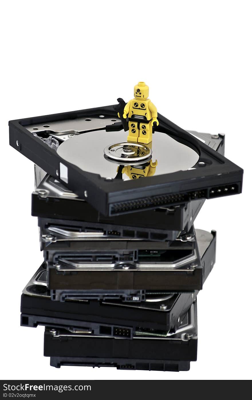 Miniature technician inspecting a hard drive