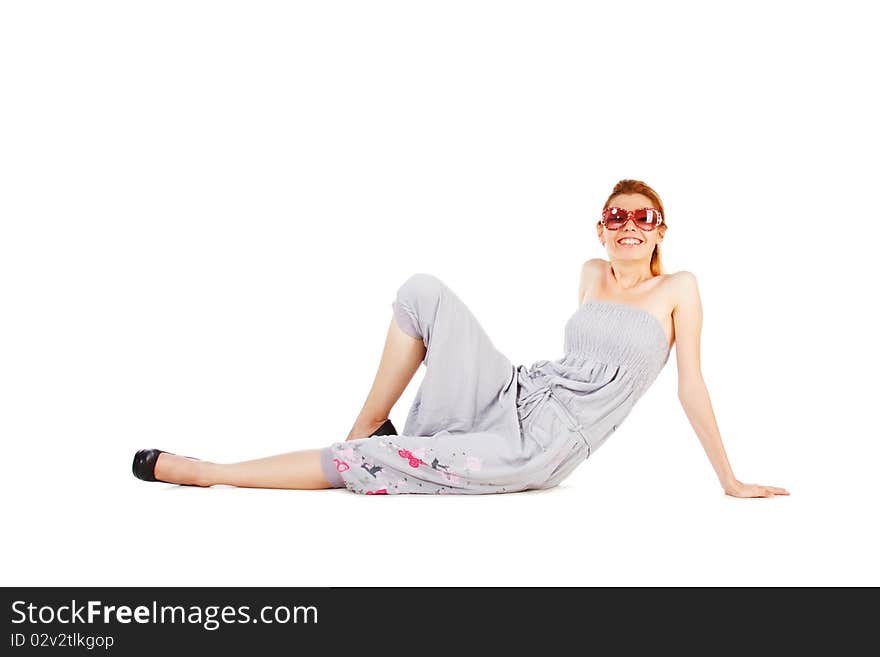 Beautiful young smiling woman in grey on floor