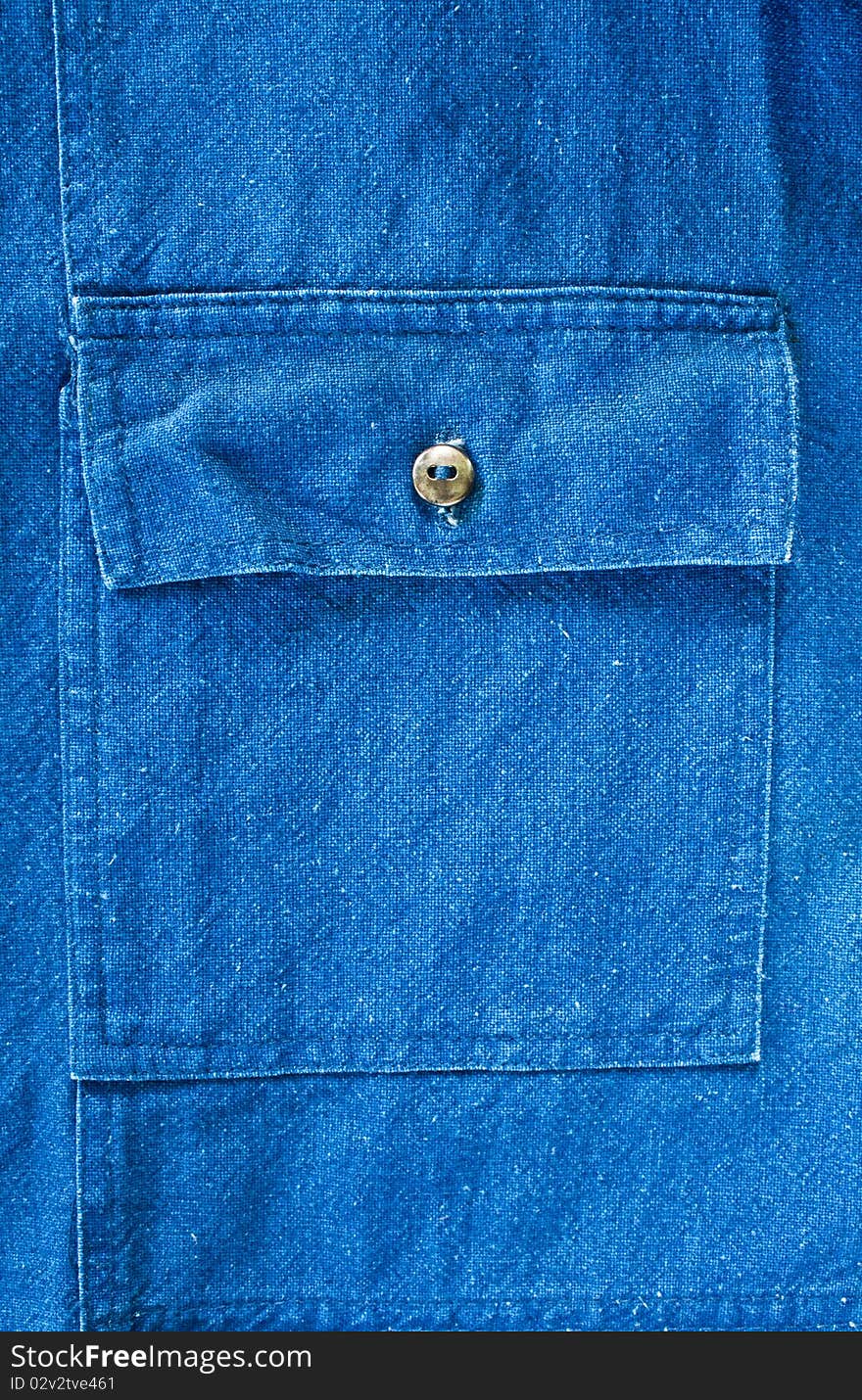 Blue pocket denim jacket fragment closeup shot