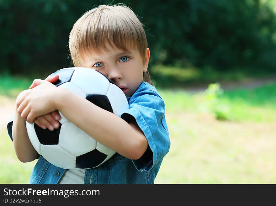 Shot of a cute boy with a ball outdoor. Shot of a cute boy with a ball outdoor.