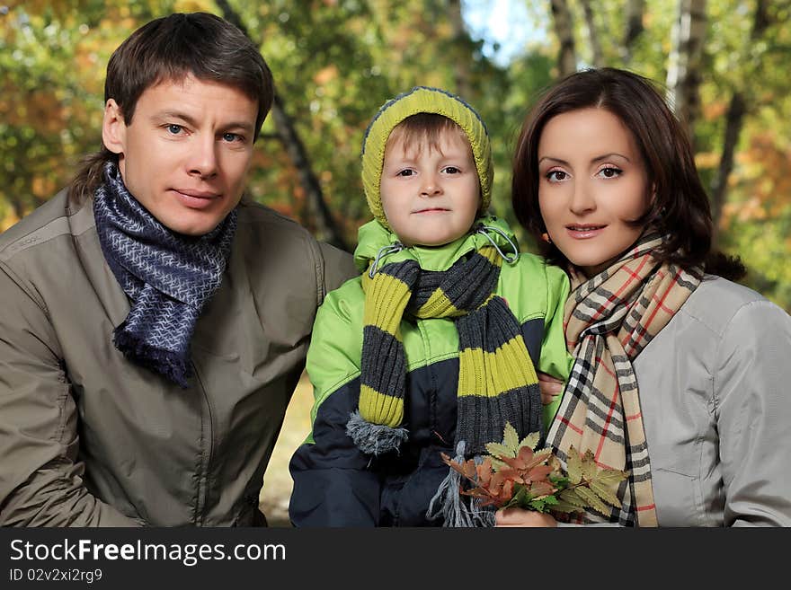 Happy family walking at the autumn park.