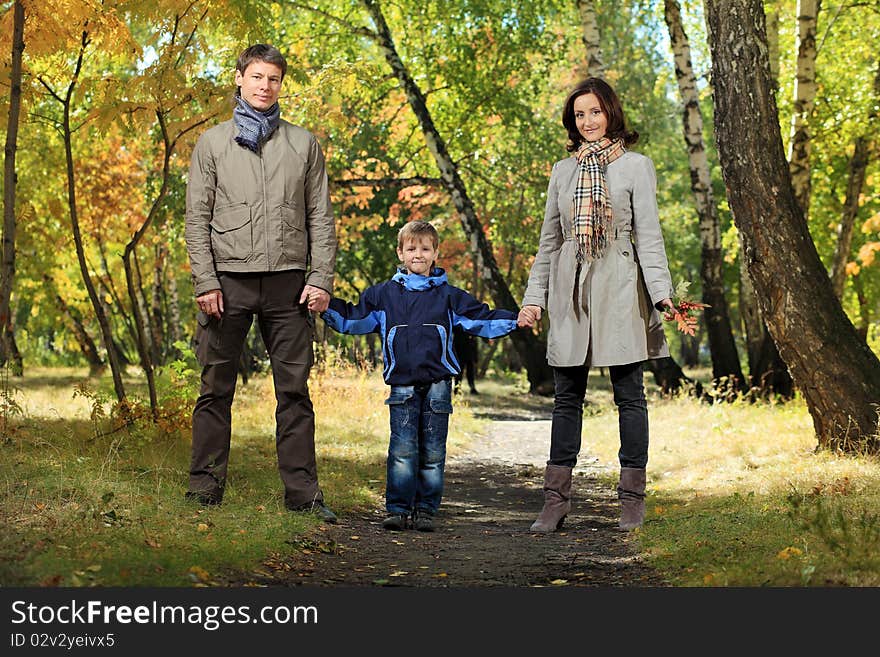 Happy family walking at the autumn park. Happy family walking at the autumn park.