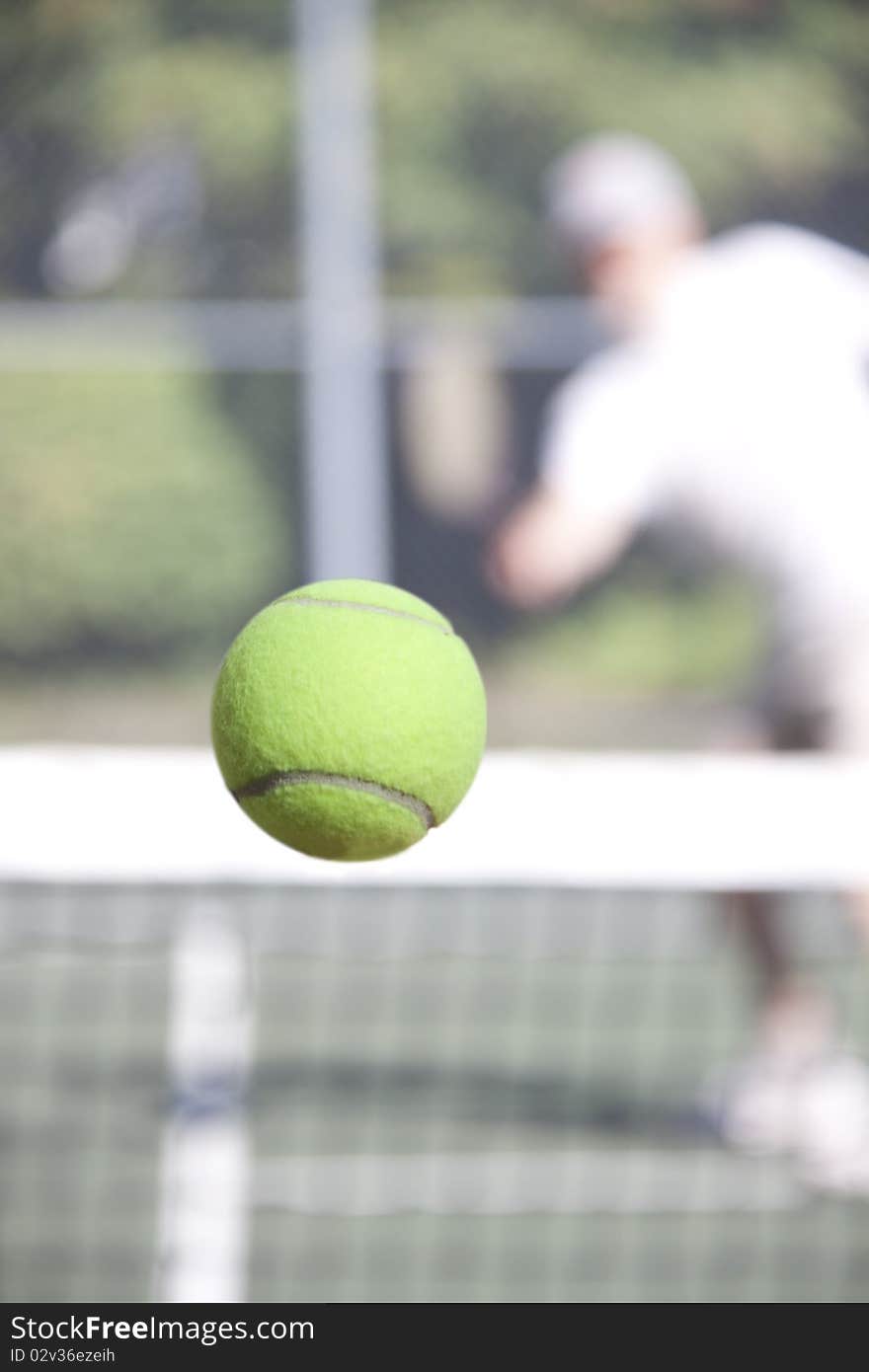 A tennis player hitting a winning down the line shot. A tennis player hitting a winning down the line shot.