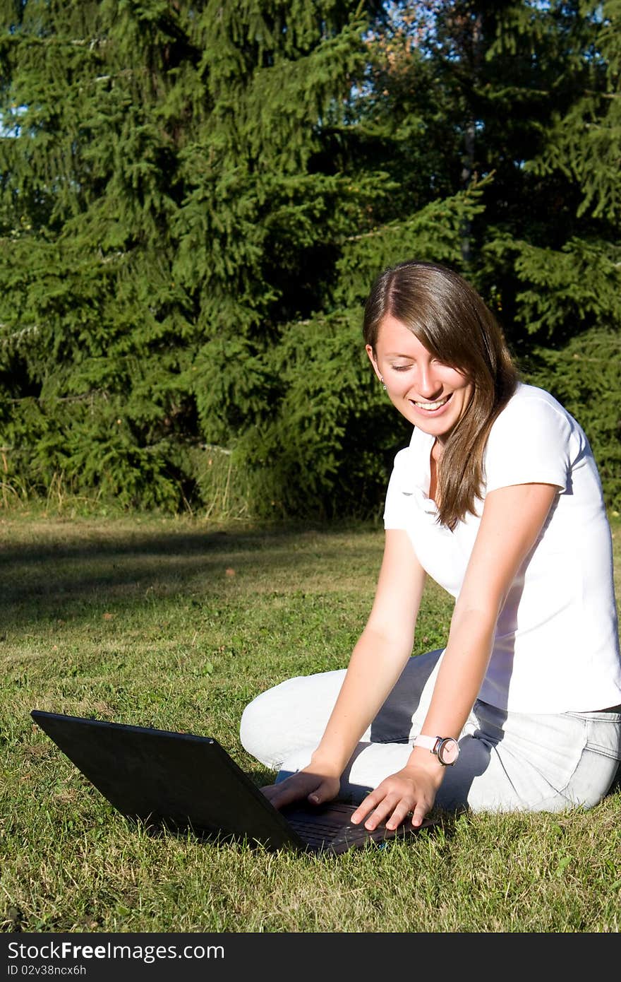 Young businesswoman working on laptop outdoor. Young businesswoman working on laptop outdoor