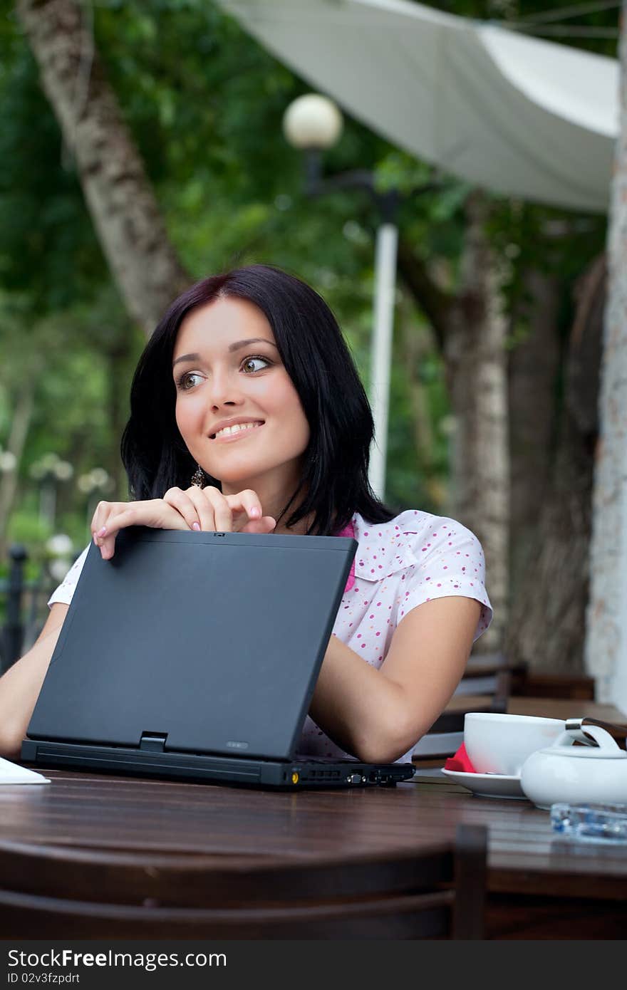 Girl with laptop in cafe