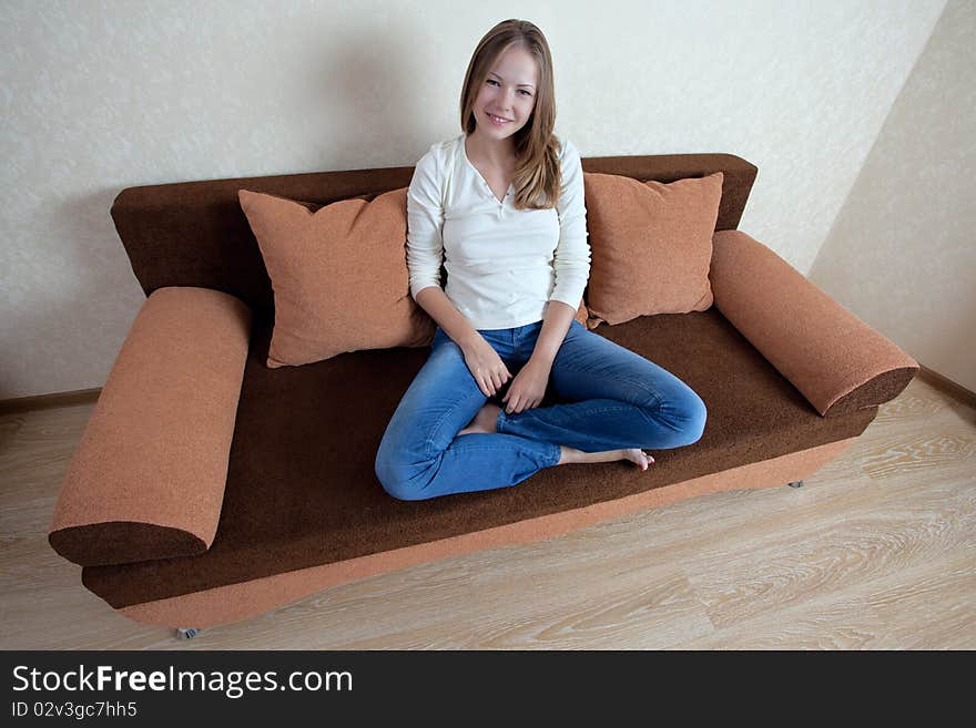 Young beatiful woman with laptop on the sofa