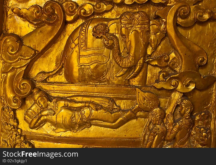 Buddha carved gold paint on church door