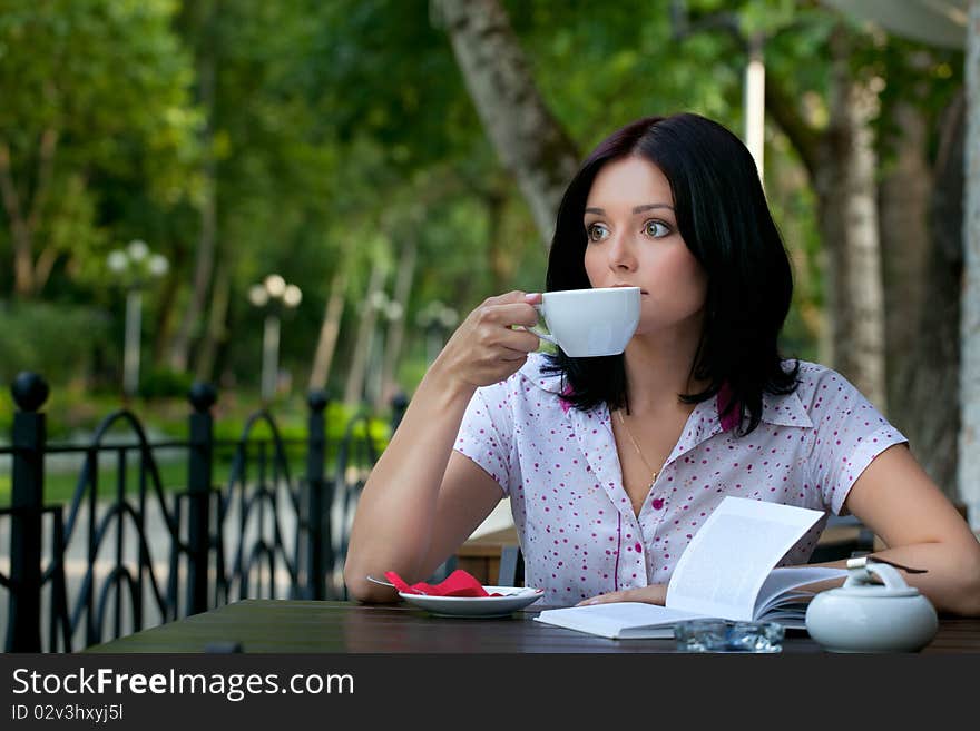 Young beautiful student girl with notepad in the cafe. Young beautiful student girl with notepad in the cafe