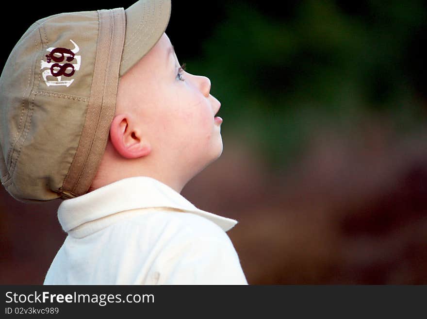 Curious Boy on train tracks with hat