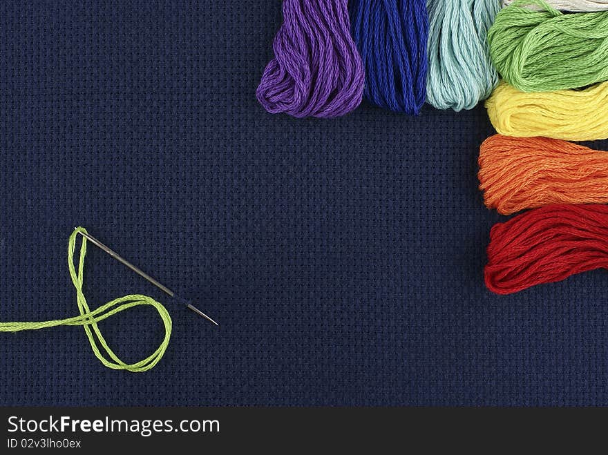 Multi-coloured threads on a dark blue background. Multi-coloured threads on a dark blue background