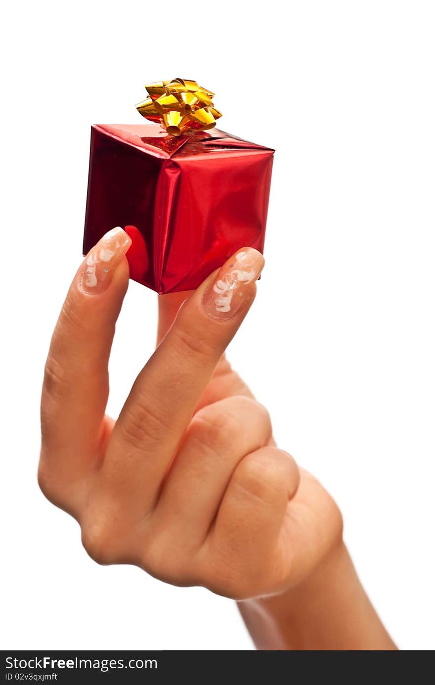 Woman's hand with a small red gift box with gold bow. White background