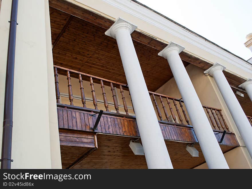 Balcony with white columns on the second floor