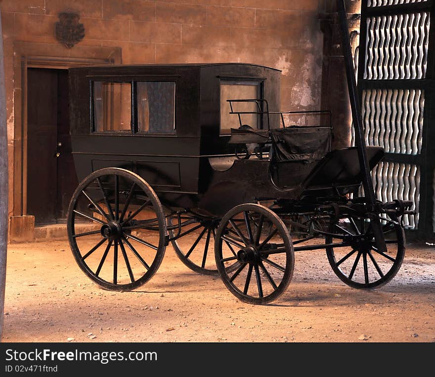 Antique black carriage in the courtyard of a palace in Mallorca