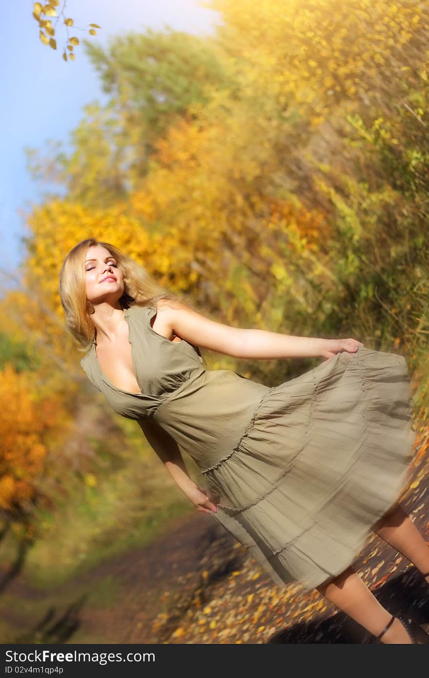 Attractive girl dances in the autumn forest