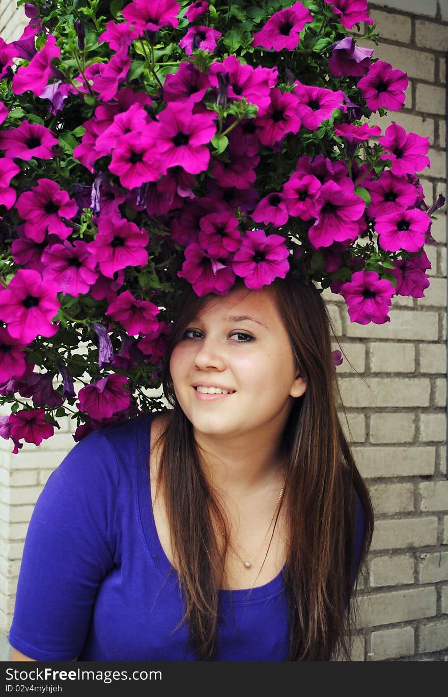 Beautiful girl in pretty hat from flowers