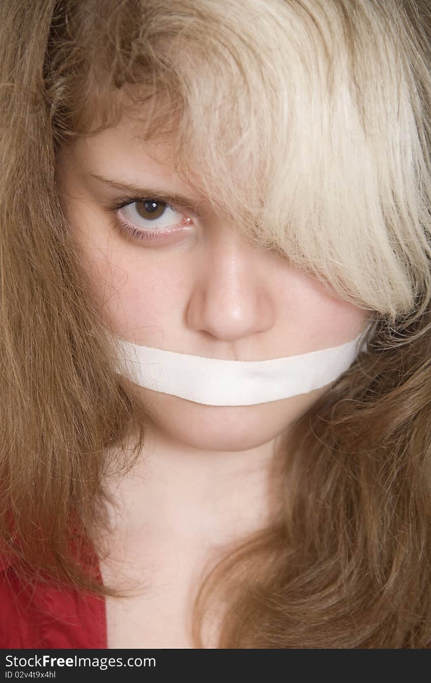 Closeup portrait of a beautyfull young girl with her mouth sealed plaster