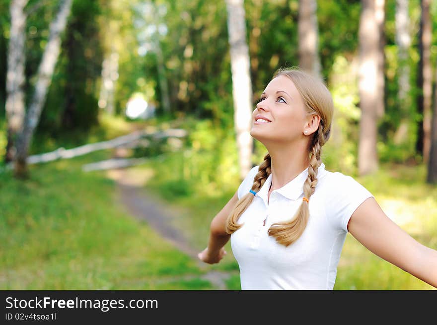 Young beautiful girl in a summer forest