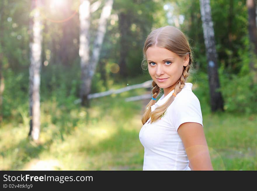 Young beautiful girl in a summer forest