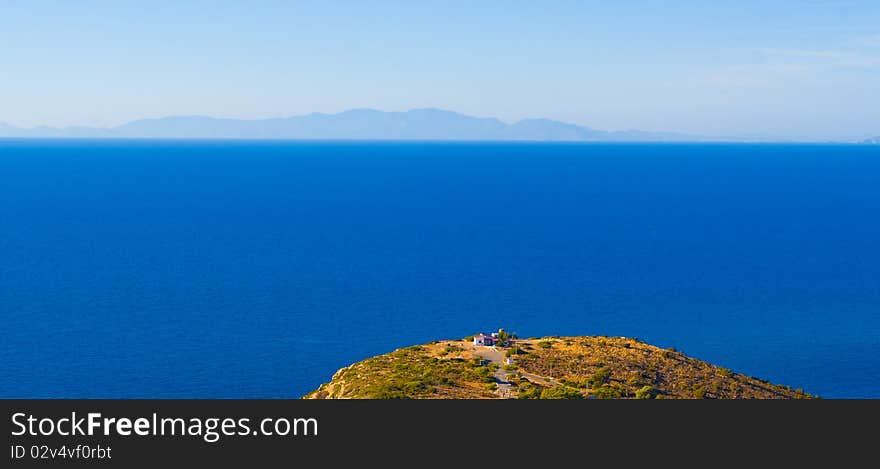 Cape, A Lone House, The Sea And The Mountains