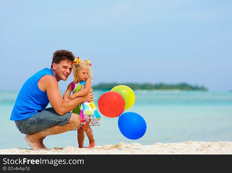 Father and his cute daughter on exotic beach